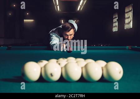 Young man preparing to shoot balls in triangle Stock Photo