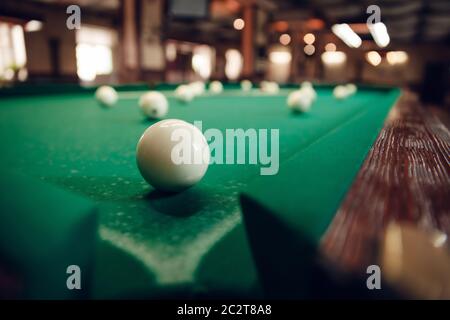 One white billiard ball near the pocket focused Stock Photo