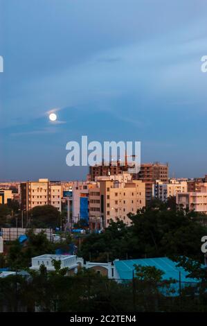 A full moon rising over the city of Hyderabad, Telangana, India.