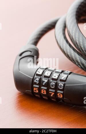 Lock for bycicle on a wooden table closeup Stock Photo