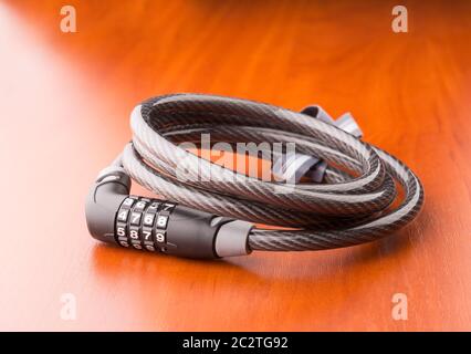 Lock for bycicle on a wooden table Stock Photo