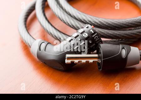 Open lock for bycicle on a wooden table Stock Photo