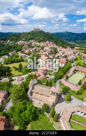 Aerial view of the church, octagonal cemetery and castle of Zavattarello. Val Tidone, Oltrepo Pavese, Province of Pavia, Lombardy, Italy. Stock Photo