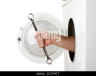 Repairman servicing washing machine. Isolated on white Stock Photo