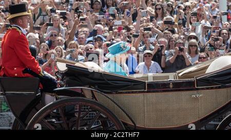Queen Elizabeth II, Queen of the United Kingdom in open carriage watched by tourists at Trooping The Colour birthday parade, London, England Stock Photo
