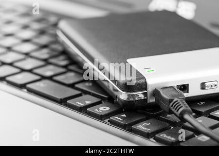 Closeup of external storage drive connected to computer Stock Photo