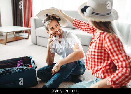 Happy couple packing their bags for vacation. Fees on journey concept. Luggage preparation Stock Photo