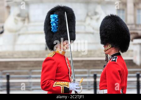 A superior inspects one of his soldiers' uniform detail and checks the posture at The Colonel's Review of Trooping the Colour military parade, London Stock Photo