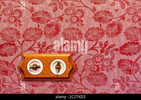 Antique wooden light switch on the wall Stock Photo