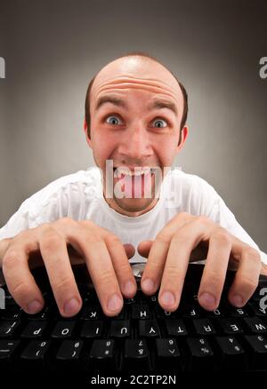 Portrait of funny nerd working on computer Stock Photo