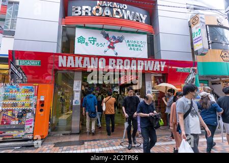 Nakano, Japan- June 14, 2020: People walk outside the entrance of a shopping mall, on a rainy day, in Nakano. Stock Photo