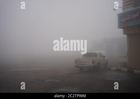 Abha / Saudi Arabia - January 23, 2020: pickup truck in dense fog in petrol station at the Asir mountains near Abha, Saudi Arabia Stock Photo