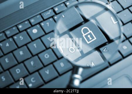 Magnifying glass focused on lock icon Stock Photo