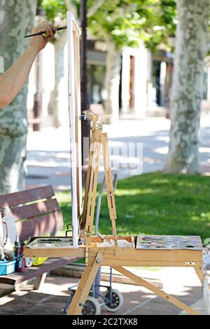 Man artist painting on the street Stock Photo