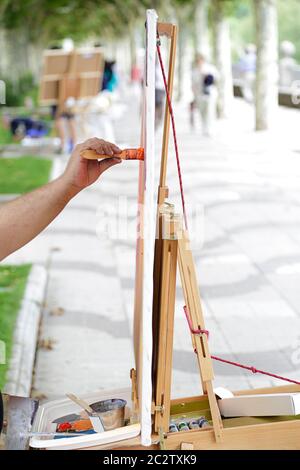 Man artist painting on the street Stock Photo