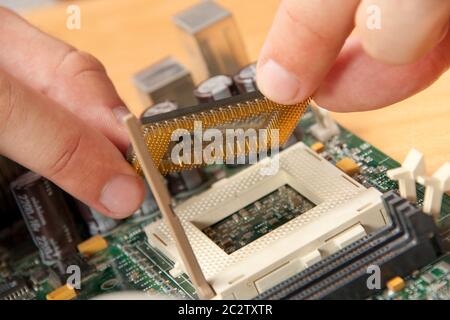 Installing computer processor to motherboard Stock Photo