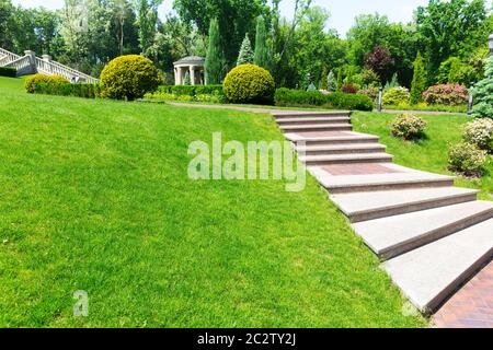 Stone pavement with stairs in green park Stock Photo