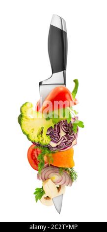 Vegetables on kitchen knife isolated on white Stock Photo