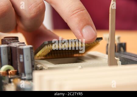 Installing computer processor to motherboard Stock Photo