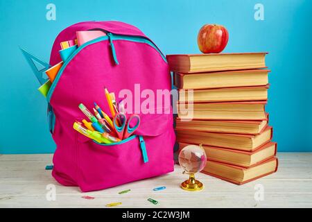 The composition is made up of books, a transparent globe and a bright briefcase. 1 September concept postcard. Concept of education or back to school Stock Photo