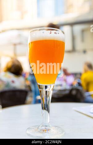 Beer in glass on the table in street cafe in old European tourist town. Summer tourism and travels, famous europe landmark, popular places for travell Stock Photo