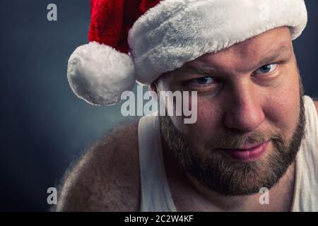 Smiling man in Santa Claus hat closeup Stock Photo