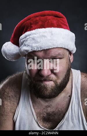 Pensive man in Santa Claus hat closeup Stock Photo