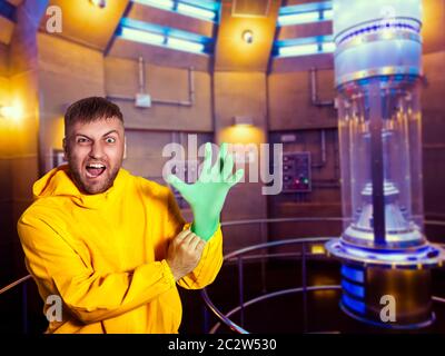 Man in protective suit putting on a rubber glove Stock Photo