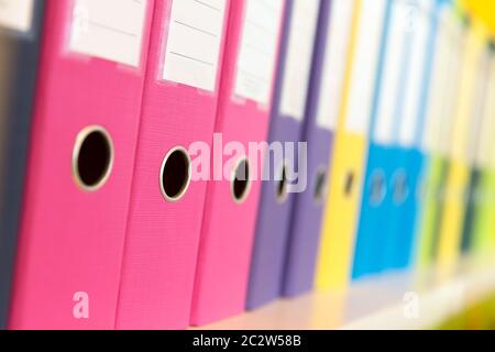 Number of folders standing on the shelf in the office Stock Photo