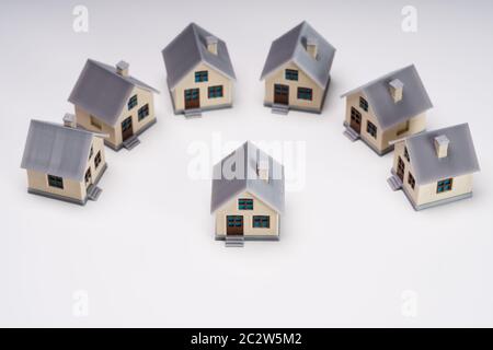 Miniature Houses Showing Standout Concept Isolated Over White Backdrop Stock Photo