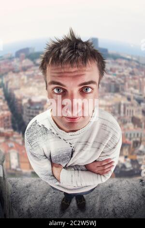 Up view of funny man standing on the roof Stock Photo
