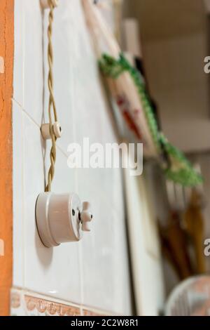 Old electric wiring with one switch on the wall in the kitchen Stock Photo