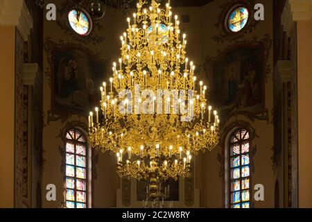 Big bronze chandelier in cathedral christian church Stock Photo