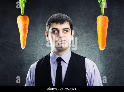 Two carrots and businessman between Stock Photo