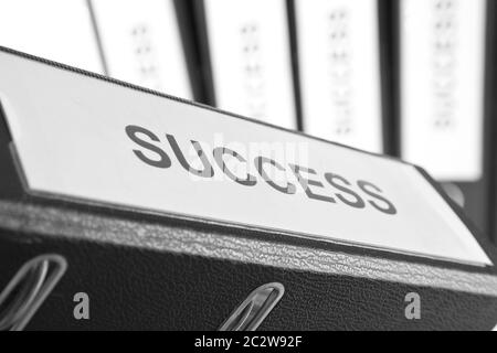 Success binder with blurred other binders in background Stock Photo