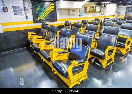 Aircraft carrier wardroom with yellow metal armchairs.Marine military museum Stock Photo