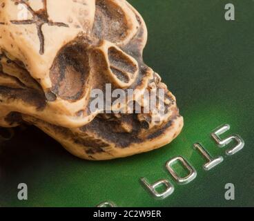 Bankruptcy concept. Human skull on credit card Stock Photo