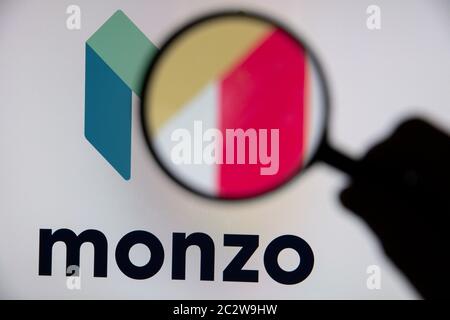 LONDON, UK - June 2020: Monzo online banking logo under a magnifying glass Stock Photo