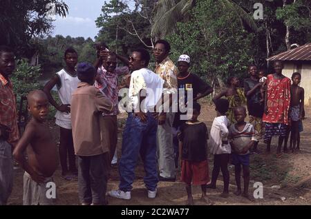 Dr Dennis Williams (floral shirt) from Sight Savers out in rural village near Bo Sierra Leone 1993 Stock Photo