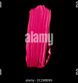 Pink lipstick brush stroke texture isolated on black background Stock Photo