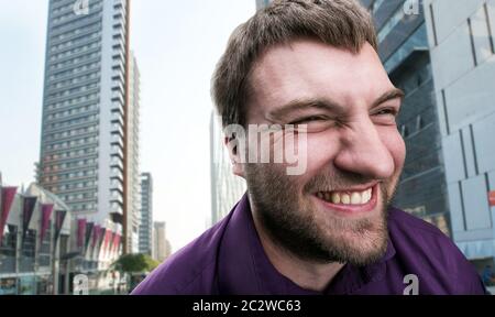 Smiling bearded man over big city background Stock Photo