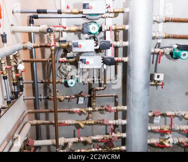 Pipes and valves of heating system indoor shot Stock Photo