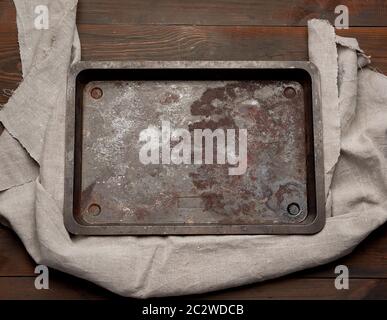 empty rectangular iron rusty baking sheet on a wooden brown table, top view Stock Photo