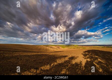 Rolling fields of South Moravia in the autumn morning with a sky full of fast-moving clouds after a storm, Moravian Tuscany, Czechia Stock Photo