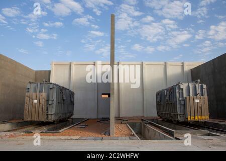 Two large transformers are being installed at an electicity sub-station that will power a new oil facility in the Sahara desert. Stock Photo
