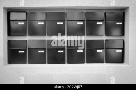 Mailboxes lined up in rows on a wall Stock Photo