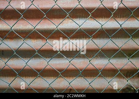 chain-link fence and corrugated-iron sheet Stock Photo