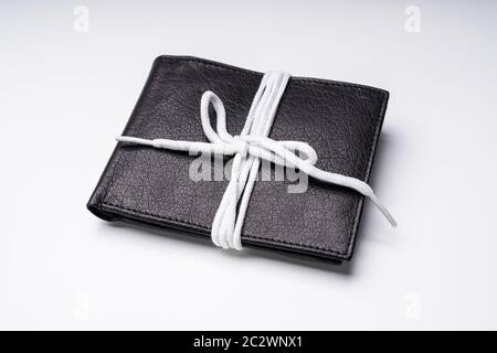 Elevated View Of Black Leather Wallet Tied With White Lace Isolated On White Backdrop Stock Photo