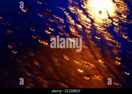 Blured abstract background with warm orange shapes and cold dark blue surroundings. Graphic resources Stock Photo