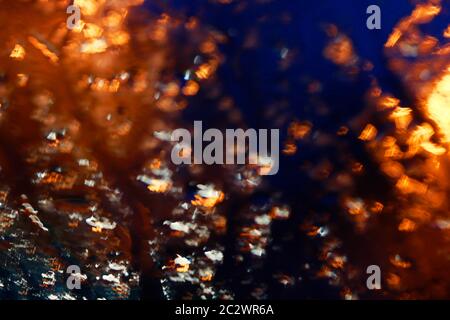 Blured abstract background with warm orange shapes and cold dark blue surroundings. Graphic resources Stock Photo
